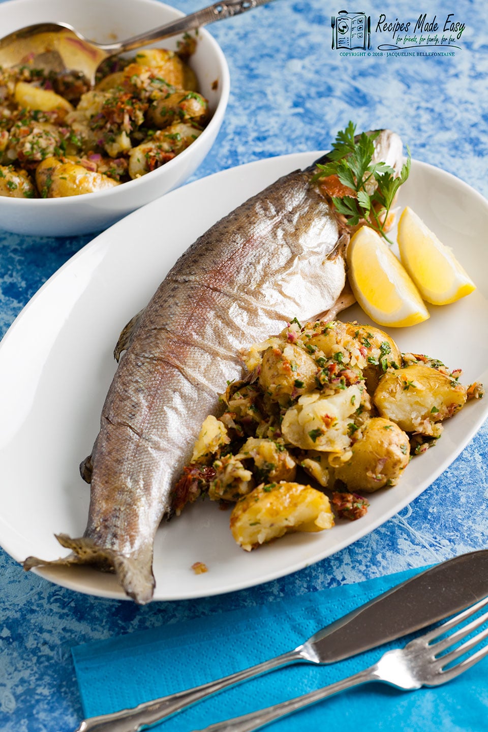 plate of oven baked trout with crushed new potatoes