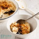 serving of blackberry rice brulee with dish in background