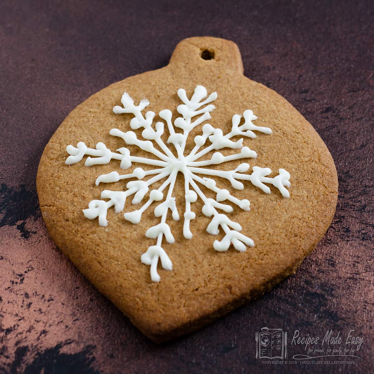 bauble shaped gingerbread cookie with iced snowflake design.