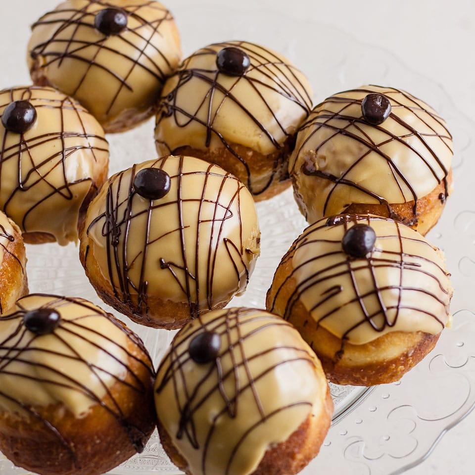 coffee and Irish cream doughnuts on a glass plate