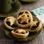 Easy Mince pies on a plate with coffee cup behind