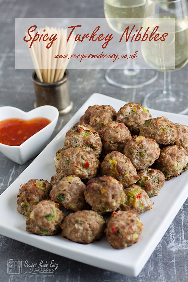 plate of spicy tureky nibbles with glasses and dipping sauce in background