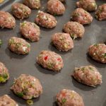 uncooked spicy turkey nibbles on a baking sheet