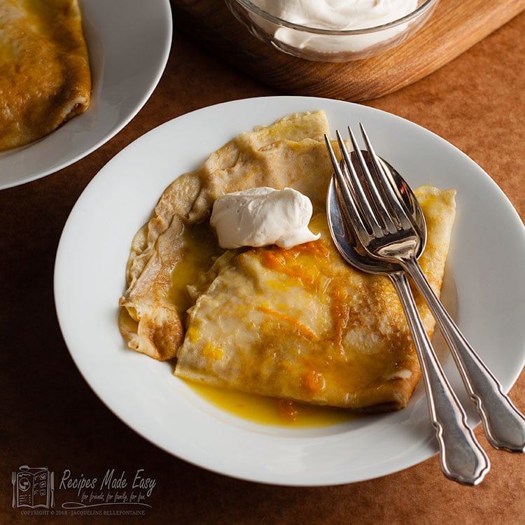 Crepes suzette served with a dollop of cream