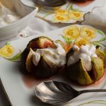 two servings of figs and ginger cream on plates with spoon