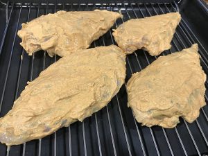 raw marinated chicken on a trivet