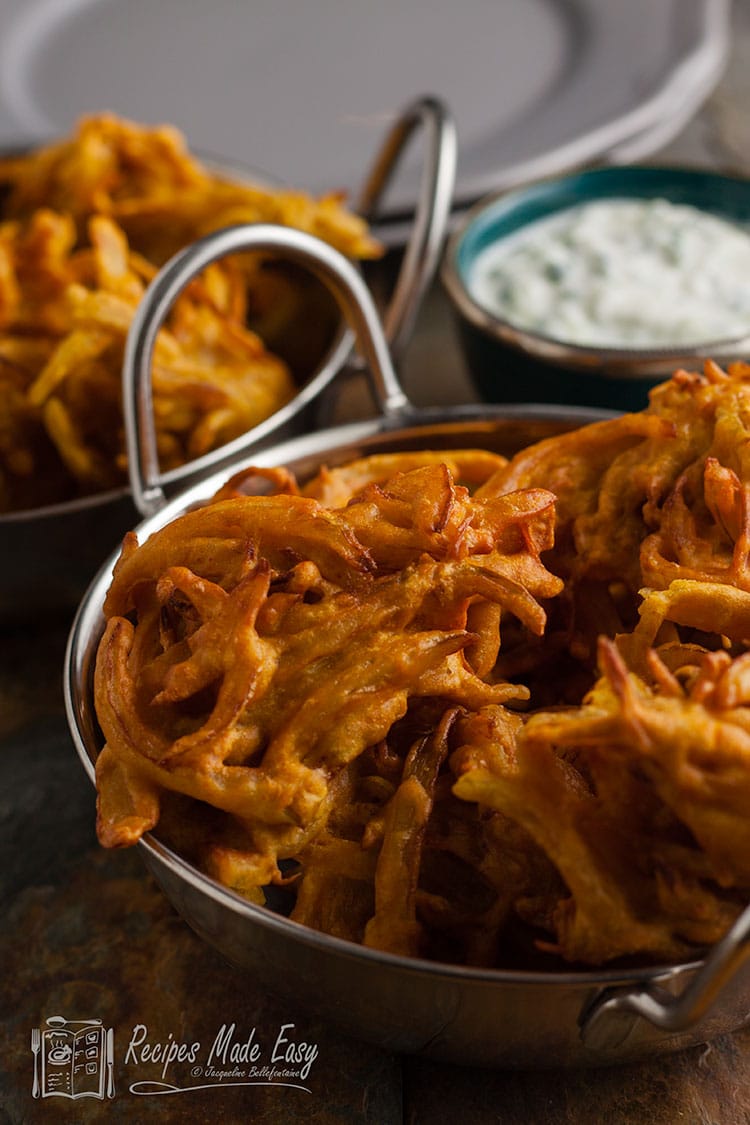 onion bhajis in bowls with bowl of cucmber raita