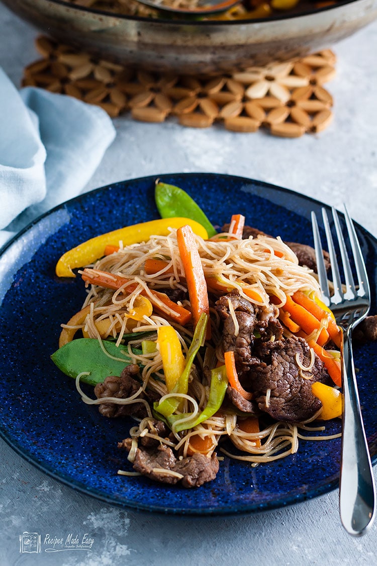 serving of beef stir fry with rice noodles