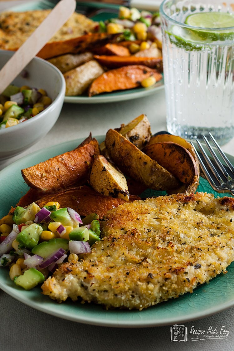 Serving of oven baked chicken schnitzel.