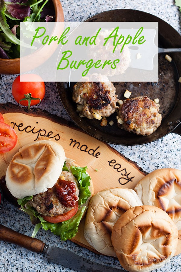 pork and apple burgers in a pan with one in a bun