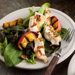 serving of warm chicken and brie salad with griddled peaches