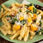 plate of pasta with roasted pumpkin and spinach.