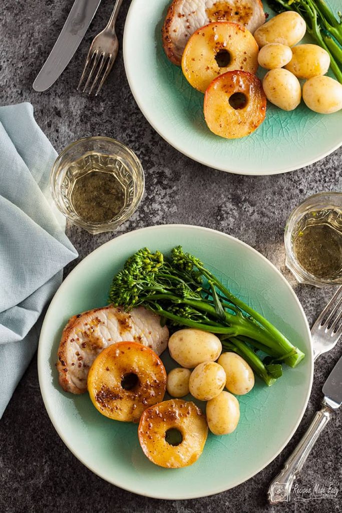 two servings of pork loin with golden apple rings