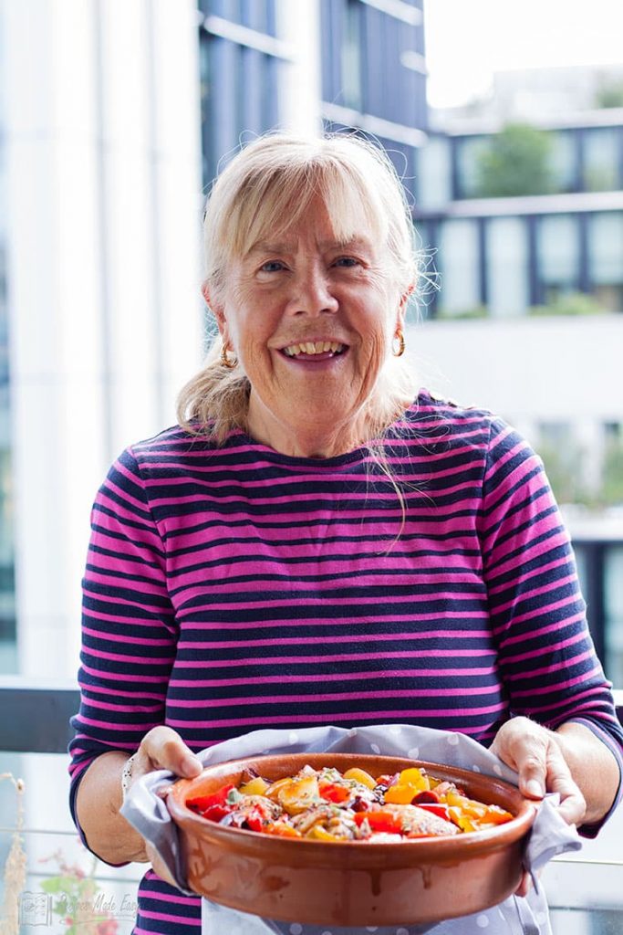 Wendy holding dish of Spanish Chicken.