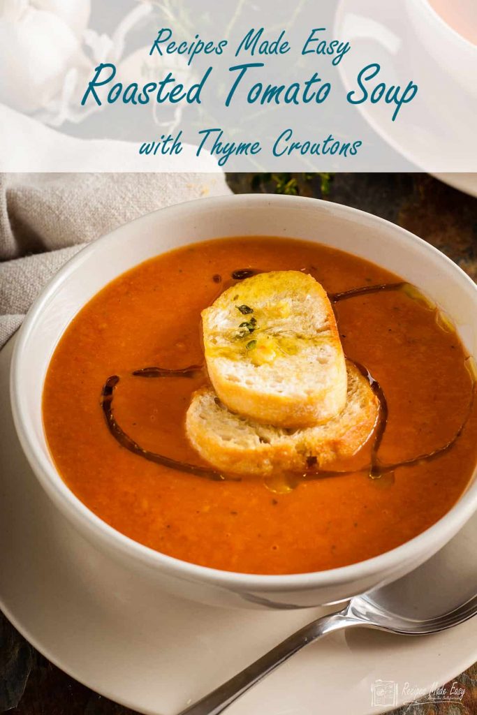 bowl of roasted tomato soup with thyme croutons on top