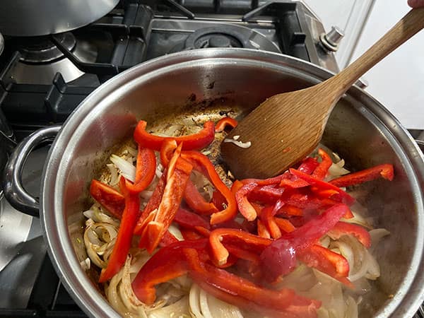 onions and red peppers in pan.