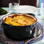 peany lamb hotpot in black casserole dish.