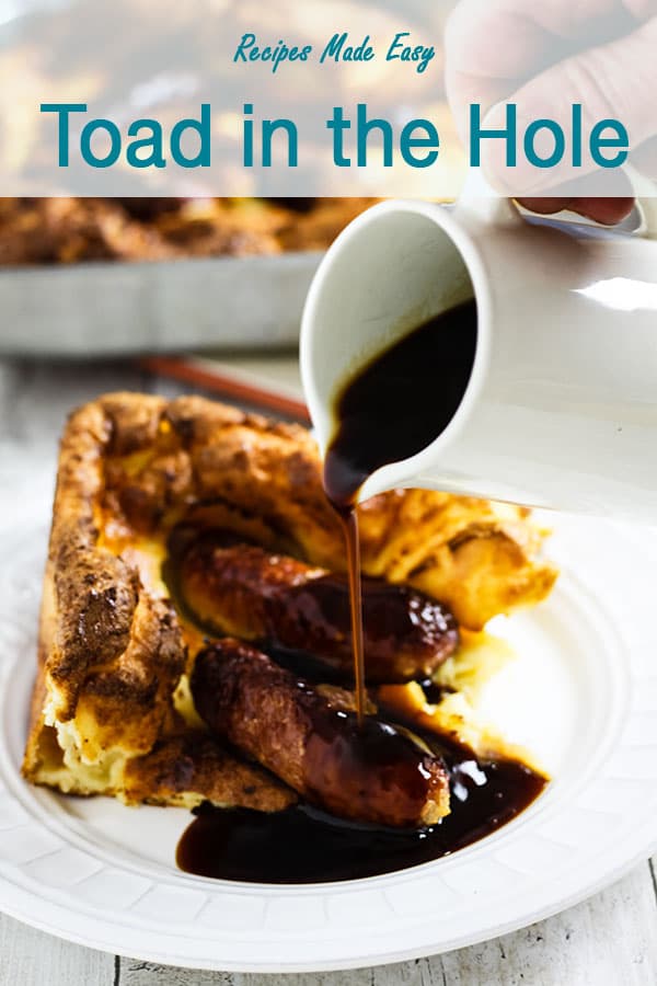Gravy poured onto a portion of toad in the hole.