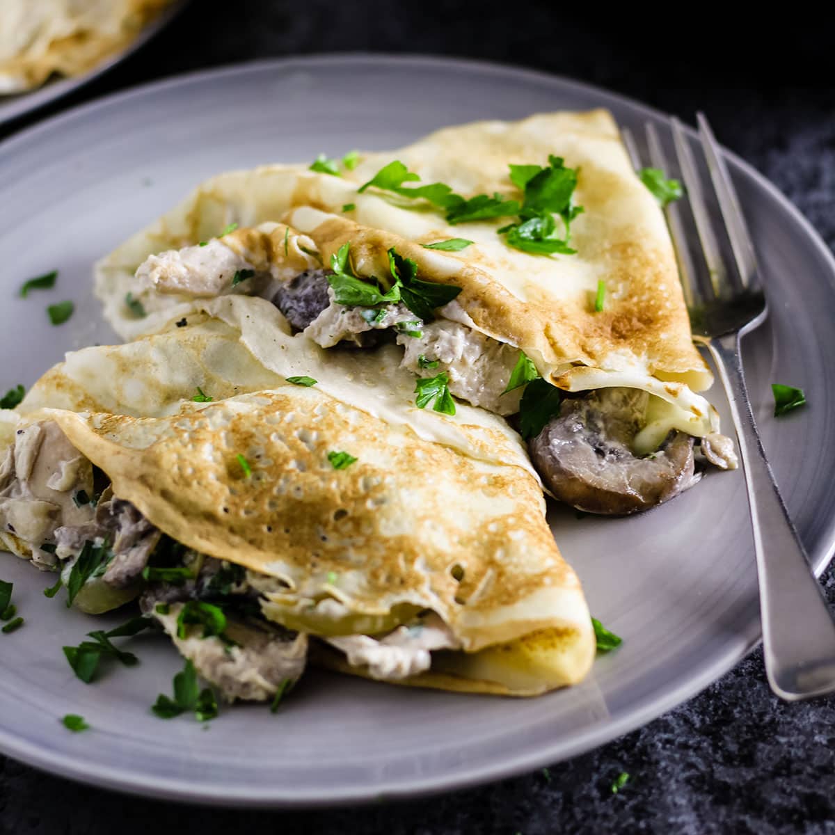 two pancakes with creamy garlic chicken and mushrooms.