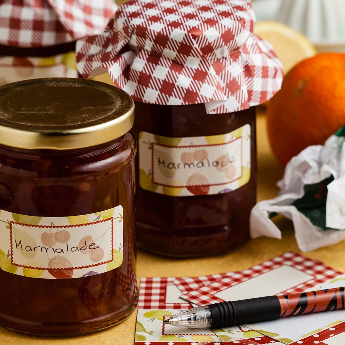 jars of quick and easy marmalade with labels on the table.
