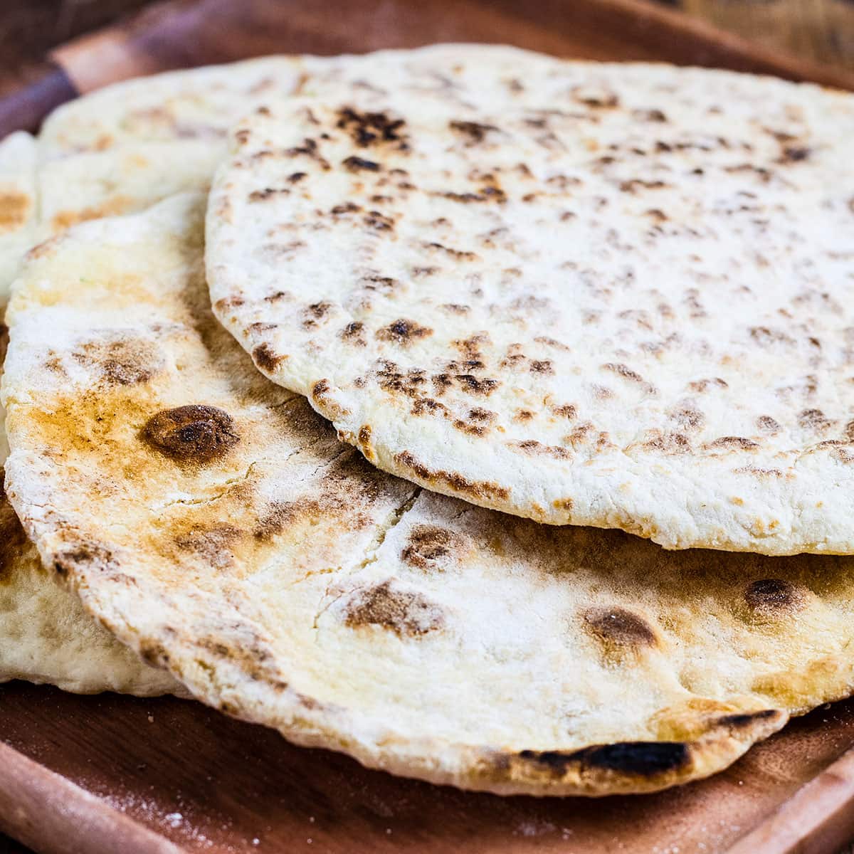 flat breads on wooden plate.