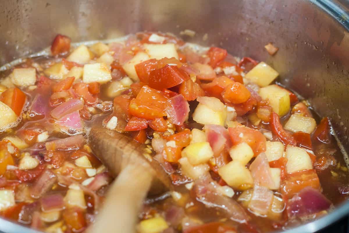 part cooked tomato chutney in pan.