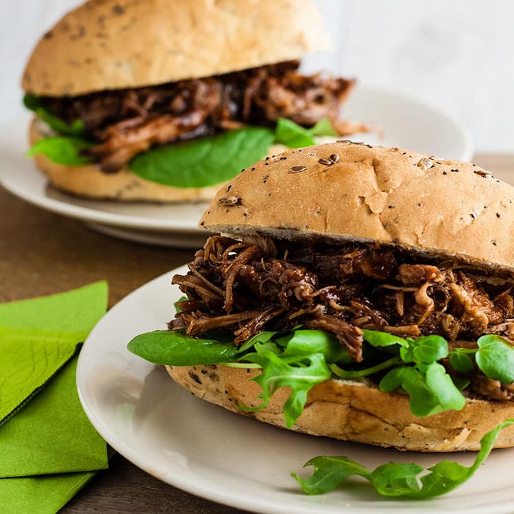 two bread rolls filled with pulled pork