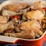 oven baked chicken and rice in oven proof dish.