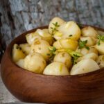 lemon and lime potato salad in wooden serving bowl.