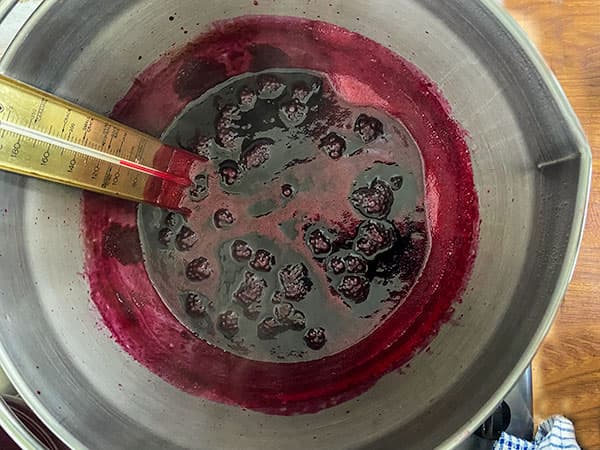 Boiled jam in pan with thermomter.