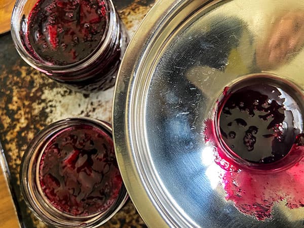 filling jars using a jam funnel.