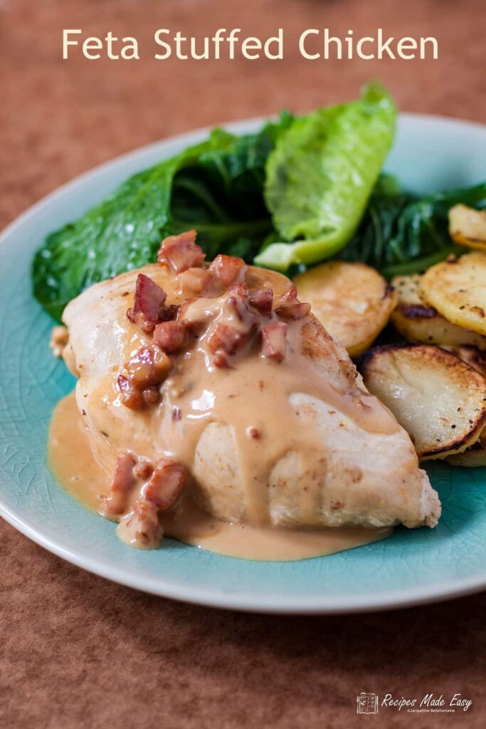 feta stuffed chicken with sauce spooned on top, shown on a plate