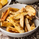 bowl of spiced roast parsnips.