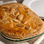 whole steak and red wine pie in baking dish.