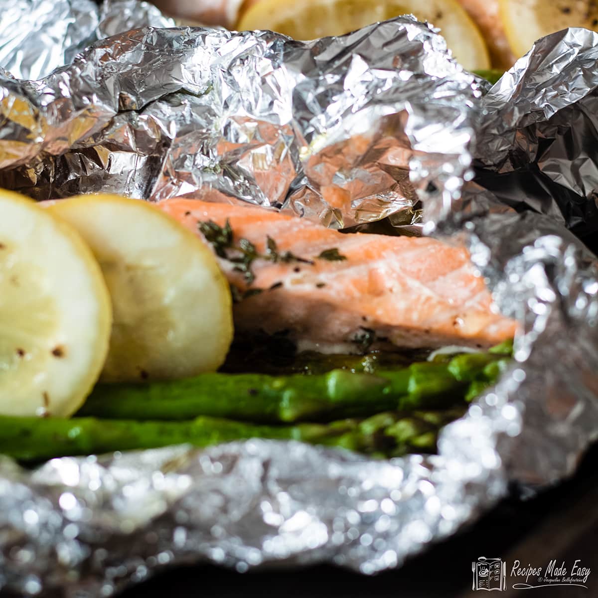 open fpil parcel with salmon and asparagus.