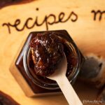 spoon of easy gooseberry chutney resting on top of jar.