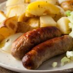 sausage and apple traybake on a dinner plate.
