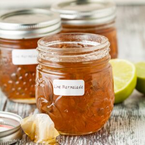 3 jars of lime marmalade front jar open.